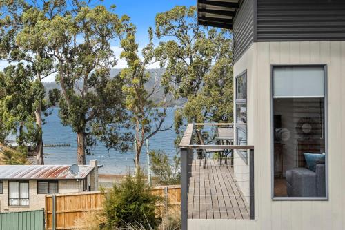 a house with a view of the water at Sunrise Cottage- Dover Tasmania in Dover