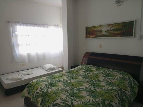 a bedroom with a bed and a window at Cabañas Privadas en Playas del Francés con Piscina in San Silvestre