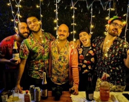 a group of men posing for a picture at a bar at Casa Pato in Mariano J. Haedo