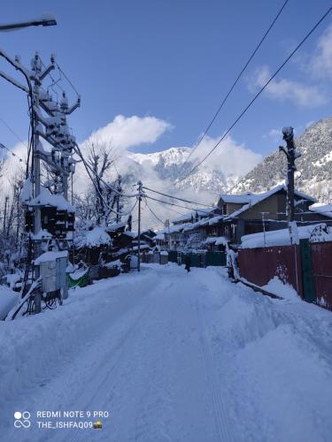 a street covered in snow with a ski lift at Betab Valley Guest House Pahalgam in Pahalgām