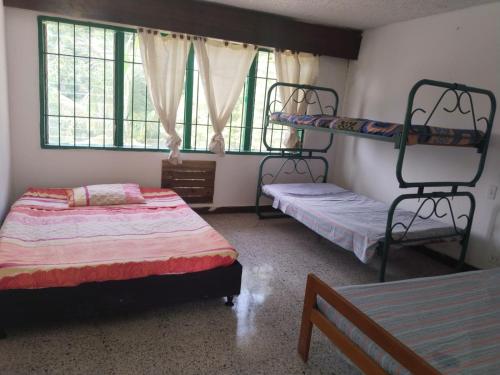a bedroom with two bunk beds and a ladder on the wall at QUINTA MARIA LUISA in Melgar