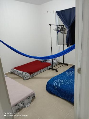 a room with two bunk beds and a blue rope at The Backpacker Nomad Green Apartment in Cancún