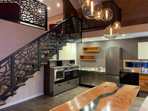 a kitchen with a spiral staircase and a stainless steel appliance at Chalet Cristal II in Les Contamines-Montjoie