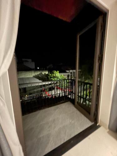 an open door to a balcony at night at The Dragon Villa Hoi An in Hoi An