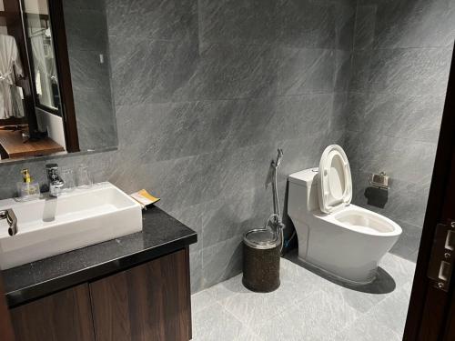 a bathroom with a white toilet and a sink at The Dragon Villa Hoi An in Hoi An