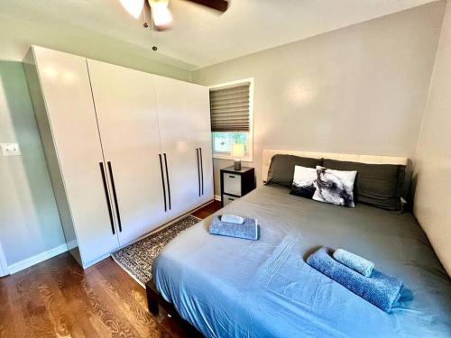 a bedroom with a large bed with two towels on it at Newly Renovated- King Suite, near WakeMed & Food in Raleigh