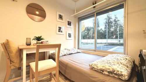 Un pat sau paturi într-o cameră la セレフォート神楽坂