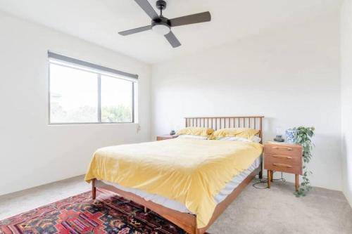 a bedroom with a bed and a ceiling fan at NEW! Funky 2BR Chermside Escape in Brisbane