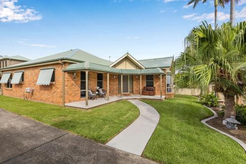 a brick house with a green roof at Serenity in Sunny Sawtell in Sawtell
