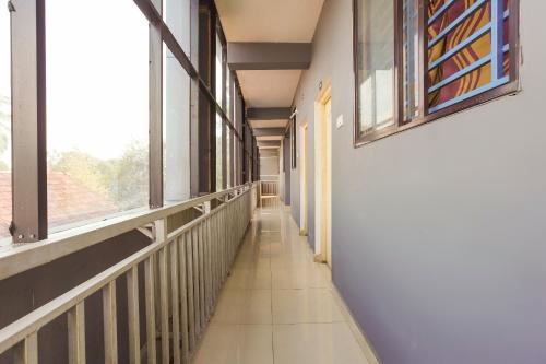an empty hallway in a building with a window at SPOT ON City Lodge in Palakkad