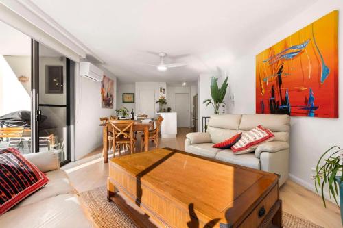 a living room with a couch and a table at Walking Distance to Darling Harbour in Sydney