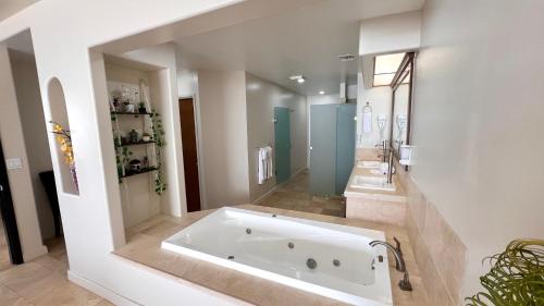 a large bathroom with a tub and two sinks at Beautiful Beach Front Condo near Downtown in Rosarito