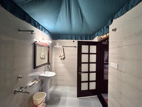 a bathroom with a sink and a blue ceiling at Royal Rajasthan Resort in Sīkar