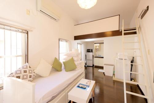 a living room with a couch and a loft bed at Mi-LOFT SHIBUYA in Tokyo