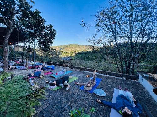 a group of people laying on the ground doing yoga at A Nhà House in Xuân Trường