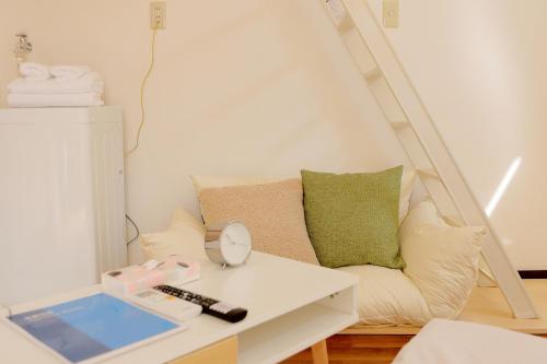 a living room with a couch and a table with a mirror at Mi-LOFT SHIBUYA in Tokyo
