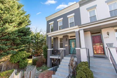 a white house with a green door at Capitol Hill Stay Like No Other in Washington