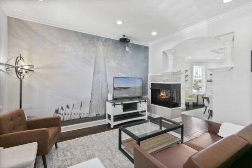 a living room with a tv and a fireplace at Capitol Hill Stay Like No Other in Washington