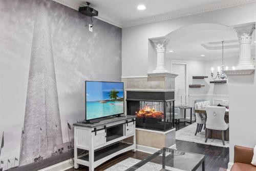 a living room with a television and a fireplace at Capitol Hill Stay Like No Other in Washington