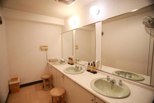 a bathroom with two sinks and a large mirror at 湘南江の島　御料理旅館　恵比寿屋 in Fujisawa