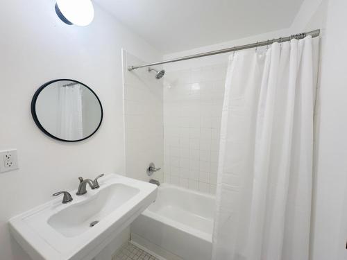 a white bathroom with a sink and a mirror at 2-BDRM Fort Lauderdale - Las Olas Beach 5 minutes walk #5 in Fort Lauderdale