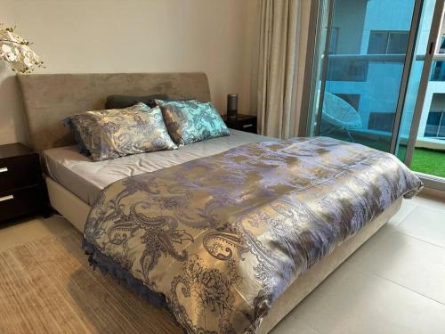 a bed with a blanket on it in a bedroom at Luxurious spacious family home in Dubai