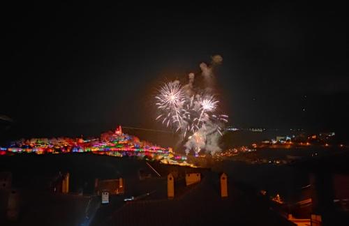 a firework display at night with a city in the background at Family House Atanasovi in Veliko Tŭrnovo