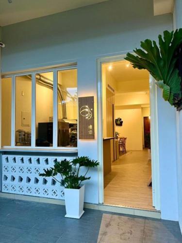 a building with a porch with a potted plant at 日月慢遊 in Yuchi