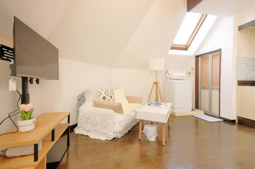 a living room with a chair and a tv at Mi-LOFT SHIBUYA in Tokyo