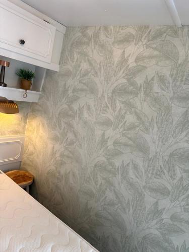 a kitchen with a pineapple wallpaper on the wall at Stacaravan 130 De Tien Heugten in Schoonloo