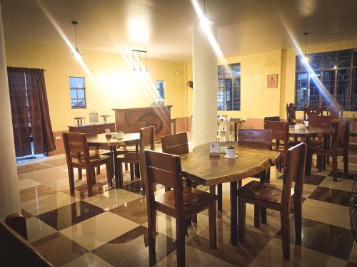 a dining room with wooden tables and chairs at Juanito's Resort in Tangalan