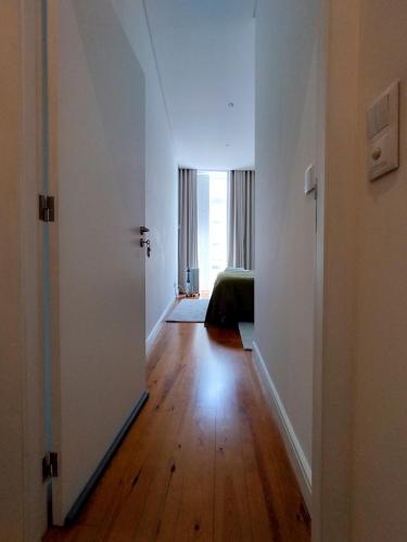 an empty room with a hallway leading to a bedroom at Casa Velha Guesthouse in Porto