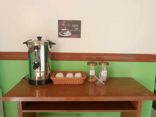 a table with a coffee maker and a basket of eggs at SG Hotel in El Nido