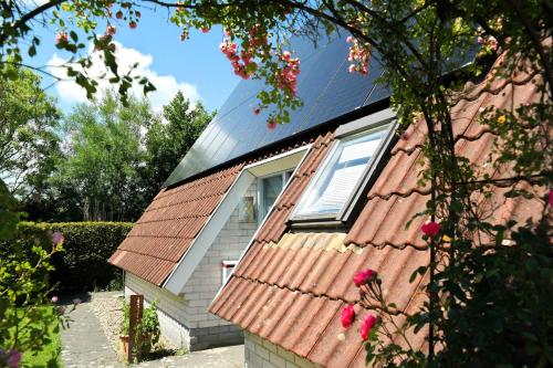 a house with a red roof and a window at Urlaubsruhe 6 Pers Holiday home w terrace close to National Park Lauwersmeer in Anjum