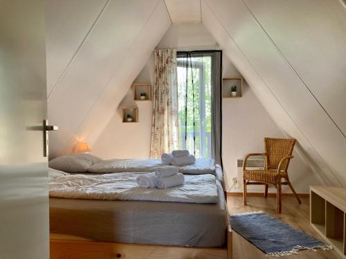 sypialnia z łóżkiem z ręcznikami w obiekcie Urlaubsruhe 6 Pers Holiday home w terrace close to National Park Lauwersmeer w mieście Anjum