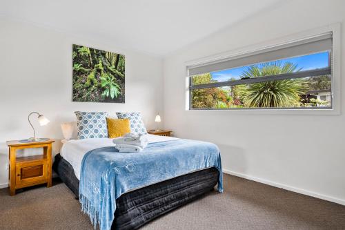 a bedroom with a bed and a large window at Cottage on Chapman in Dover