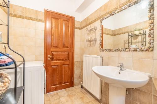 a bathroom with a sink and a mirror at Ilios Country house in Arillas