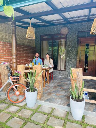 two people sitting at a table on a patio at La Casa Bella in Ella