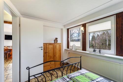 a bedroom with a bed and a sink and a window at Ferienwohnungen Zum Hasenbahnhof in Kirchhundem