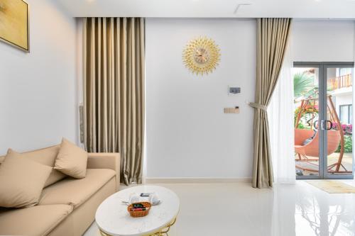 a living room with a couch and a table at Greenlife Village Phú Quốc in Phu Quoc