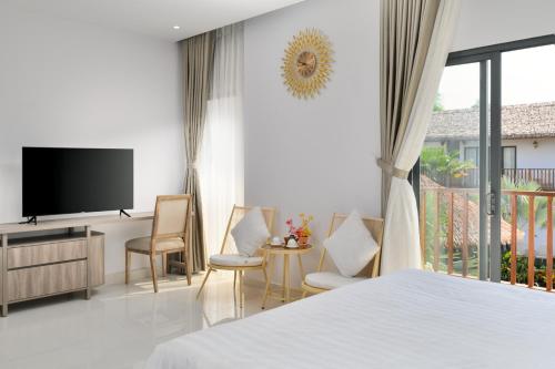 a bedroom with a bed and a flat screen tv at Greenlife Village Phú Quốc in Phu Quoc