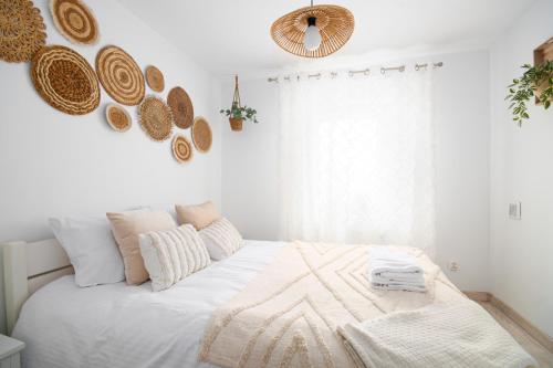 a white bedroom with a bed with a blanket on it at Pod Trzynastką Cosy Apartment in Jelenia Góra