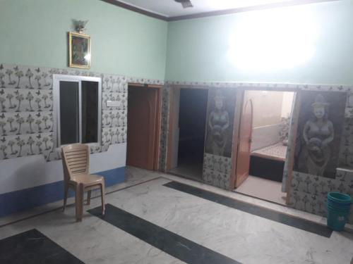 a room with a chair and a bed in it at Mahesh Guest House Ajmer in Ajmer