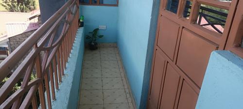 a hallway with a red door and a tile floor at Siwarani Cozy Two bedroom,Kamakis Eastern Bypass Ruiru in Ruiru