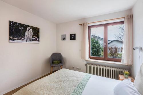 Schlafzimmer mit einem Bett und einem Fenster in der Unterkunft Ferienwohnung Schwarzwaldblick in Weil am Rhein