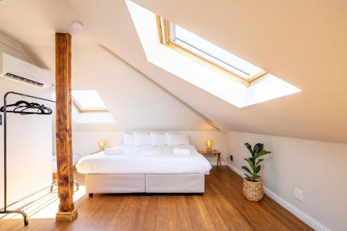 a bedroom with a bed and a skylight at Villa Viva Cape Town in Cape Town