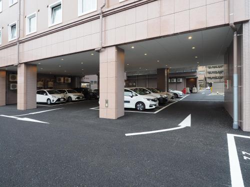 a parking lot with cars parked inside of a building at Toyoko Inn Nagoya Meieki Minami in Nagoya