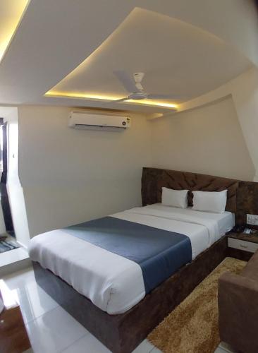 a bedroom with a large bed in a room at signature hotel in Ahmedabad