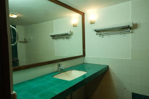 a bathroom with a sink and a mirror at 2 BHK beach goan villa with pool calangute in Calangute