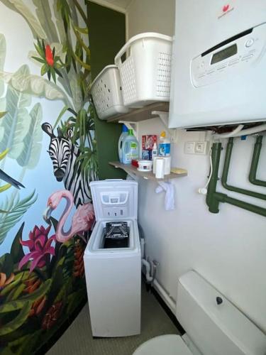 une cuisine avec une cuisinière blanche four supérieur à côté d'un mur dans l'établissement Villa 4* Proche centre et plage. Animaux bienvenus, à Meschers-sur-Gironde